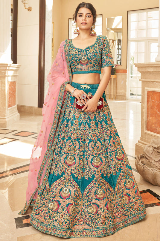 Ingenious Embroidered Teal Color Velvet Fabric Wedding Wear Lehenga