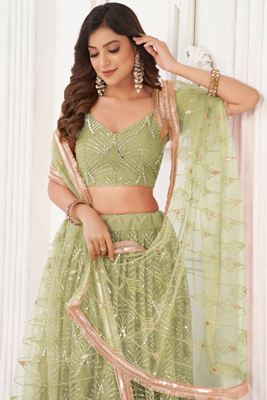Net Fabric Function Wear Magnificent Lehenga In Green Color With Sequins Work