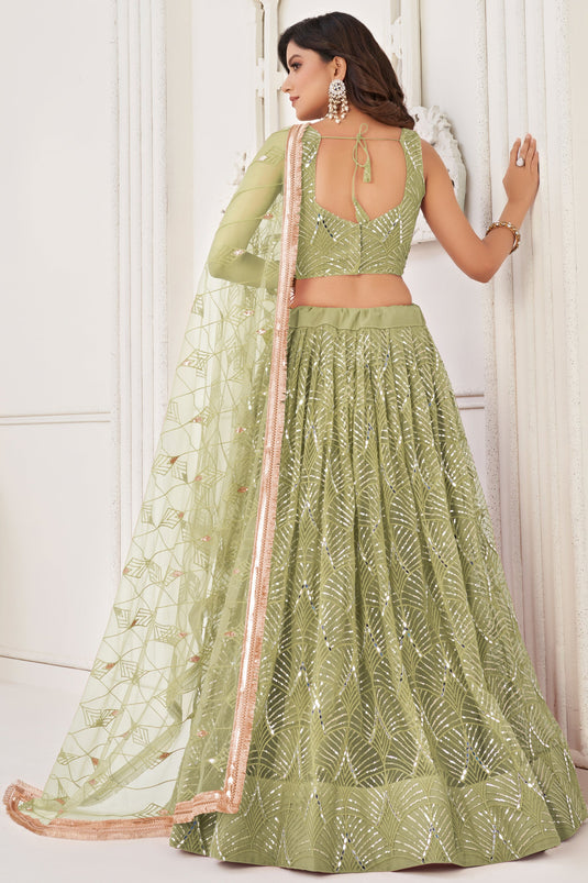 Net Fabric Function Wear Magnificent Lehenga In Green Color With Sequins Work
