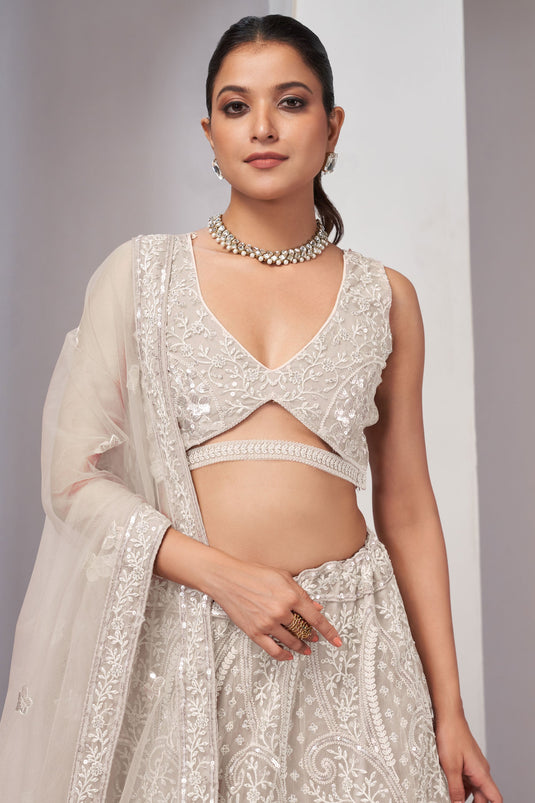 Off White Color Net Fabric Coveted Lehenga With Sequins Work