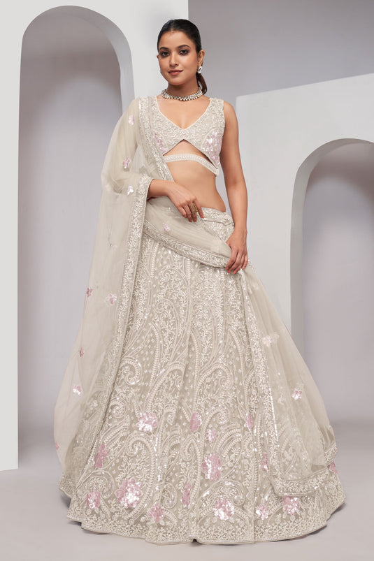 Off White Color Net Fabric Coveted Lehenga With Sequins Work