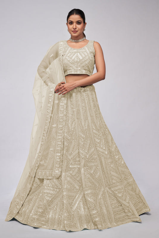 Beige Color Net Fabric Engaging Lehenga With Sequins Work