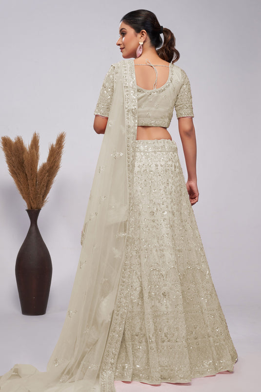 Soothing Sequins Work On Off White Color Net Fabric Lehenga