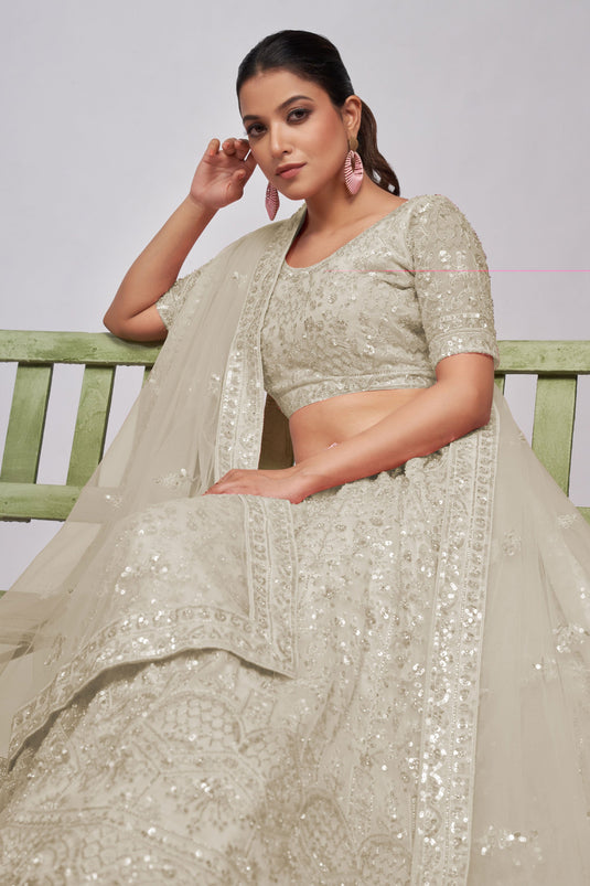 Soothing Sequins Work On Off White Color Net Fabric Lehenga