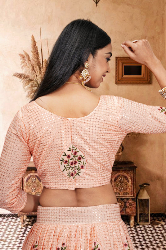 Trendy Net Fabric Peach Color Lehenga With Sequins Work