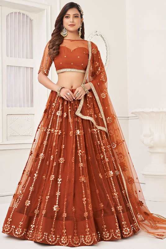Tempting Net Fabric Rust Color Lehenga Choli With Embroidered Work