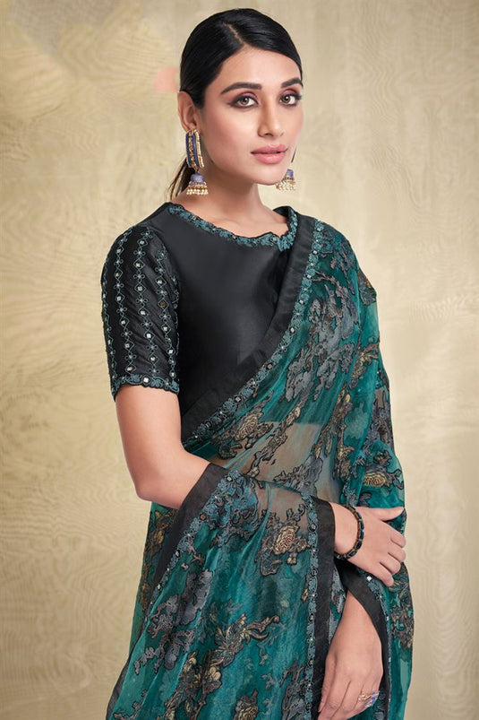 Fancy Fabric Teal Color Saree With Soothing Printed Work