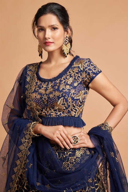 Sangeet Wear Net Fabric Classic Navy Blue Color Lehenga With Embroidered Designs