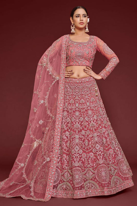 Tempting Net Fabric Peach Color Lehenga With Embroidered Work