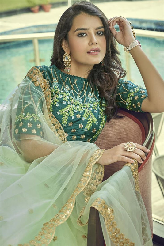 Tempting Net Fabric Sea Green Color Lehenga With Embroidered Work