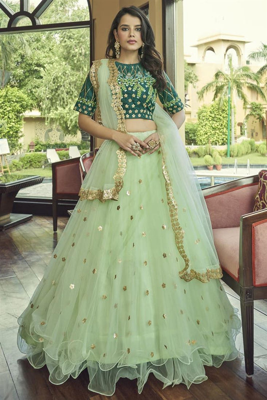 Tempting Net Fabric Sea Green Color Lehenga With Embroidered Work