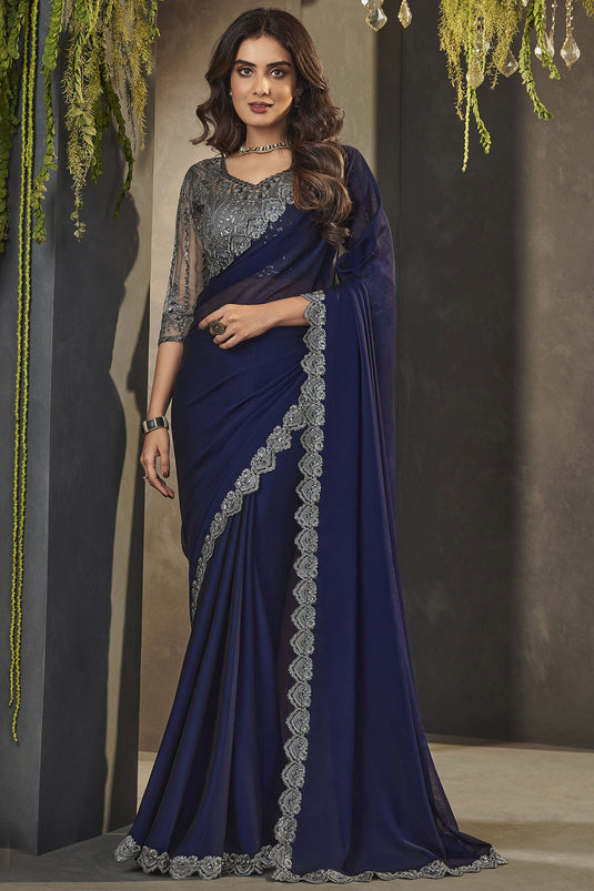 Lavishing Blue Color Georgette Fabric Lace Border Work Saree With Embroidered Blouse