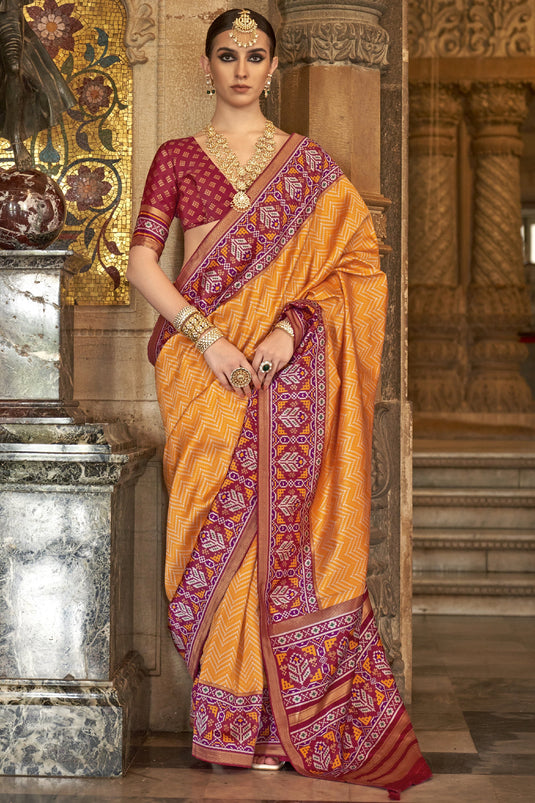 Dazzling Orange Color Art Silk Fabric Printed Function Wear Patola Saree