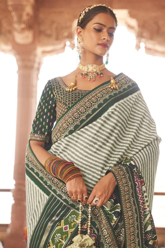 Function Wear Patola Silk Fabric Dark Green Color Printed Magnificent Saree With Semi Stitched Blouse