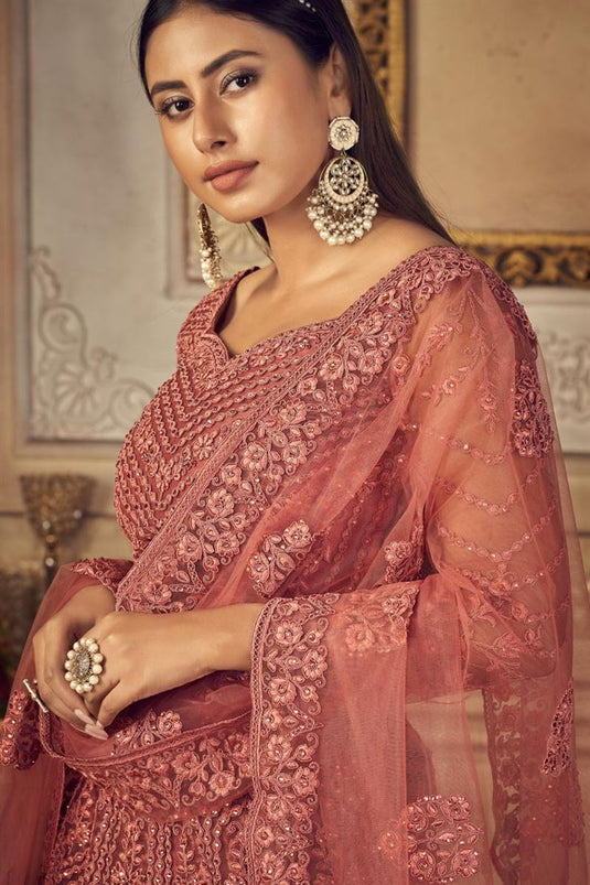 Beautiful Net Fabric Sangeet Wear Embroidered Lehenga Choli In Peach Color