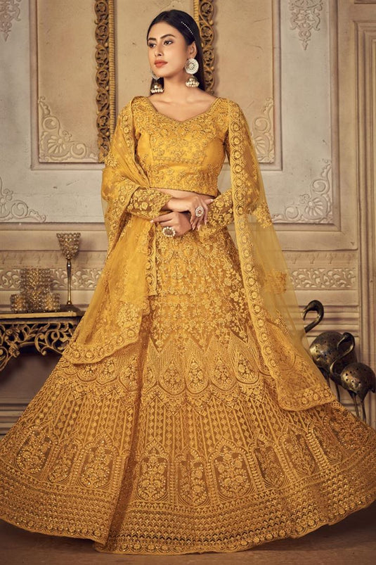 Sangeet Wear Glamorous Embroidered Net Lehenga Choli In Mustard Color
